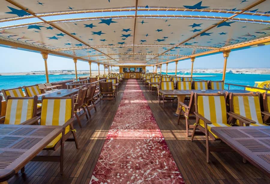 From Makadi: Nefertari Sunset or Morning Cruise With pickup - First look underwater: panoramic windows on the air-conditioned deck